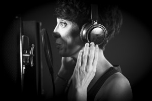 Voiceover artist recording text in studio
